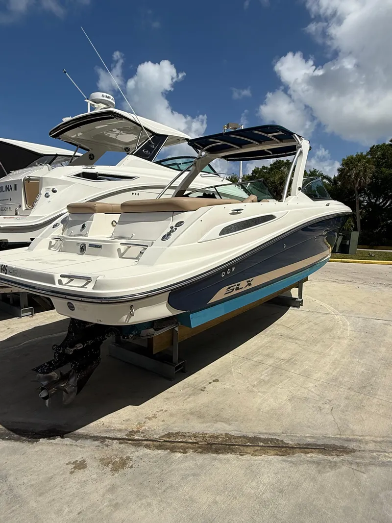 Slide: The Image of 2014 Sea Ray 270 SLX boat on display under a clear blue sky. - 8