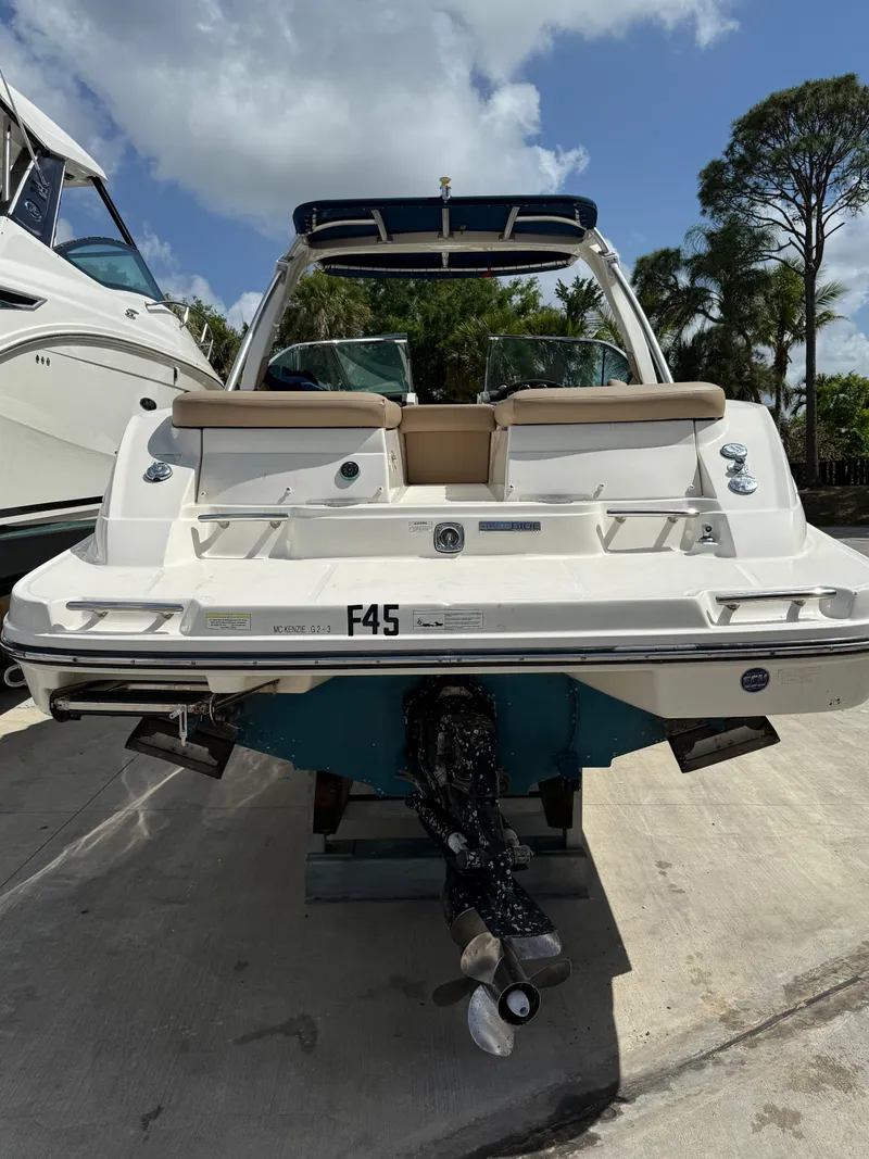 Slide: The Image of 2014 Sea Ray 270 SLX boat, rear view, docked under a cloudy sky. - 9