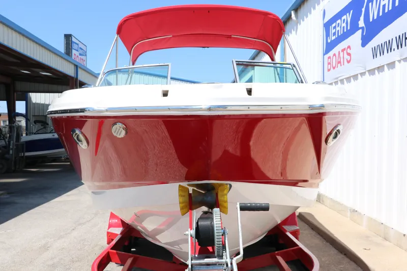Slide: The Image of 2016 Chaparral 246 SSi boat with red hull and canopy on trailer. - 10