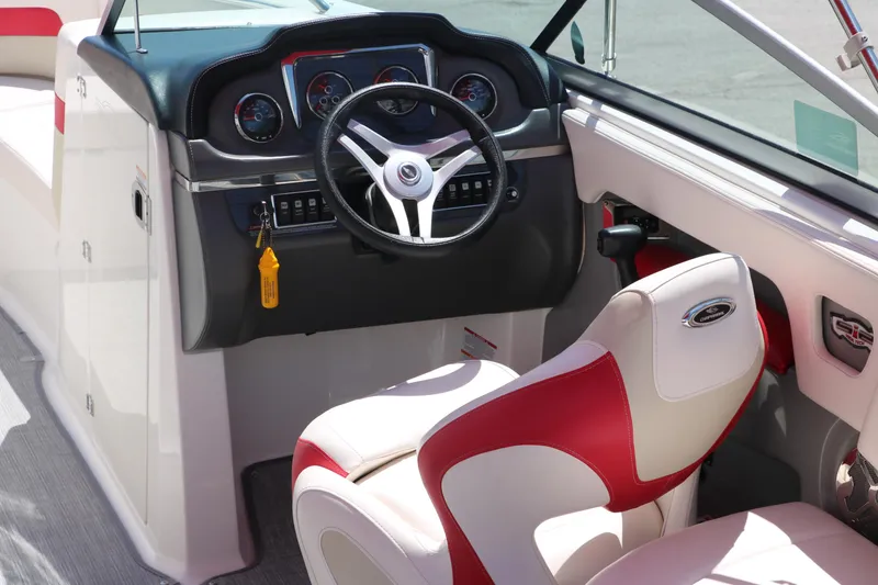 Slide: The Image of 2016 Chaparral 246 SSi boat interior with steering wheel and red-white seating. - 19
