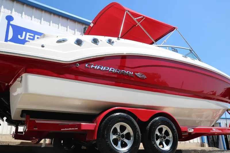 Slide: The Image of 2016 Chaparral 246 SSi boat with red and white design on a trailer. - 2