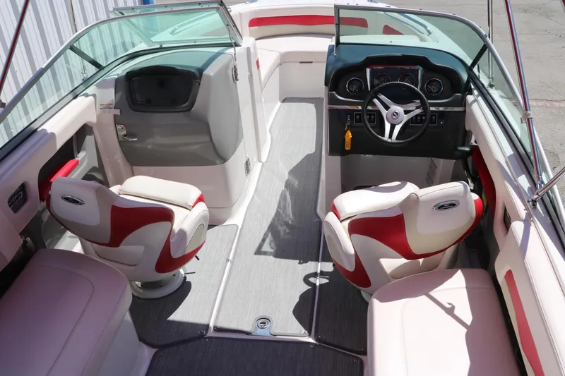 Slide: The Image of 2016 Chaparral 246 SSi boat interior with red and white seating, steering wheel, and dashboard. - 22