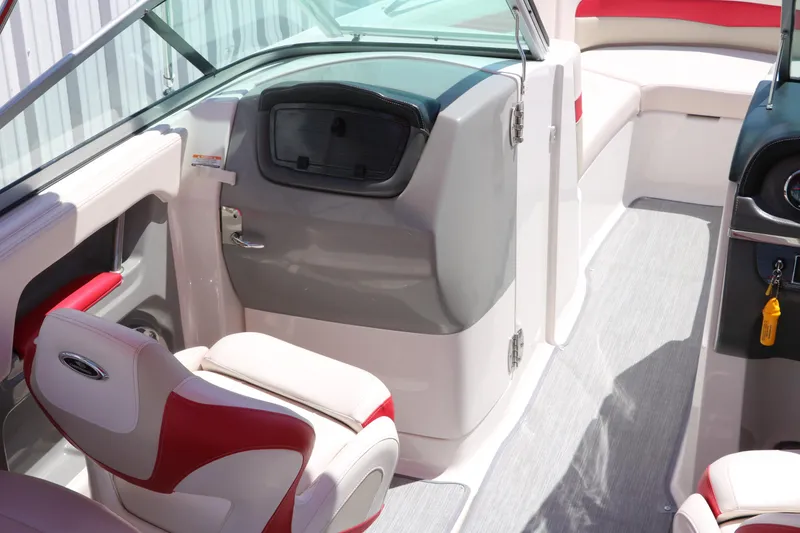 Slide: The Image of 2016 Chaparral 246 SSi boat interior with red and white seating, modern dashboard. - 23