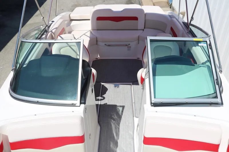 Slide: The Image of 2016 Chaparral 246 SSi boat interior with red and white seating, open windshield. - 27