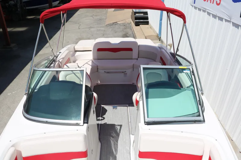 Slide: The Image of 2016 Chaparral 246 SSi boat with red canopy and spacious seating. - 28