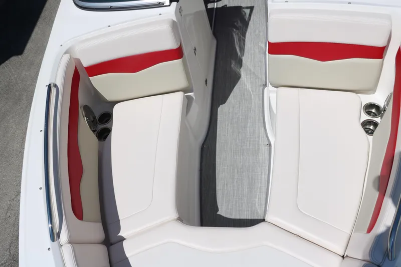 Slide: The Image of 2016 Chaparral 246 SSi boat interior with white and red seating, cup holders, and gray flooring. - 29