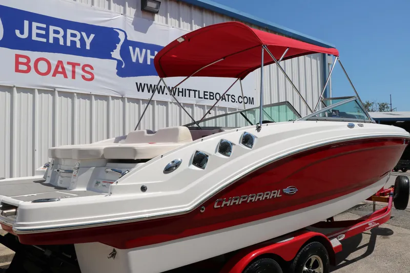 Slide: The Image of 2016 Chaparral 246 SSi boat with red hull and canopy on trailer. - 3