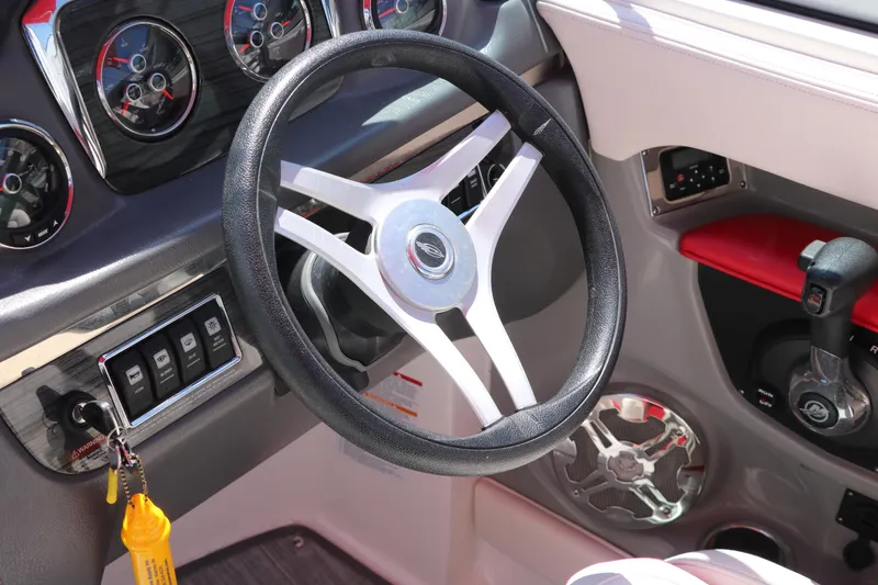 Slide: The Image of Steering wheel and dashboard of 2016 Chaparral 246 SSi boat. - 32