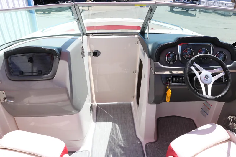 Slide: The Image of 2016 Chaparral 246 SSi boat interior with steering wheel and dashboard controls. - 33