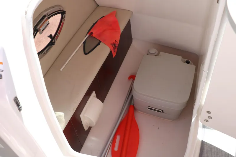 Slide: The Image of Interior of 2016 Chaparral 246 SSi boat with portable toilet and safety equipment. - 36