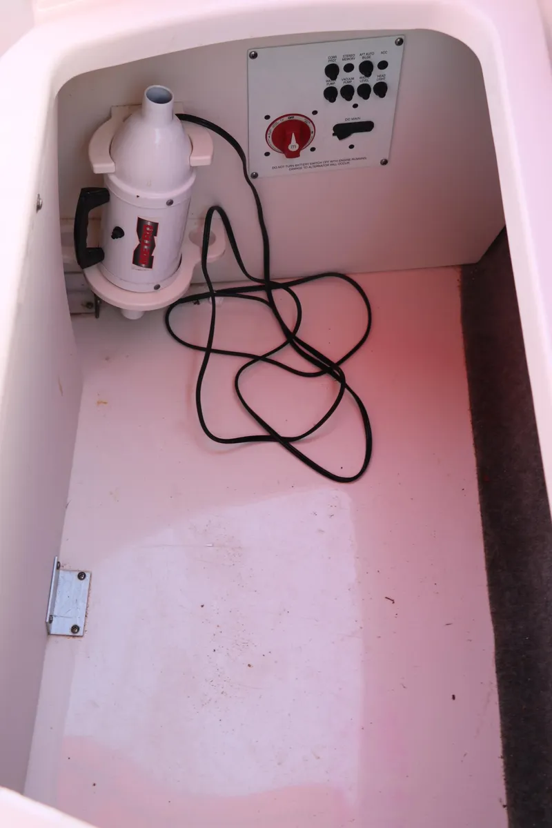 Slide: The Image of Storage compartment in 2016 Chaparral 246 SSi boat with electrical panel and equipment. - 37