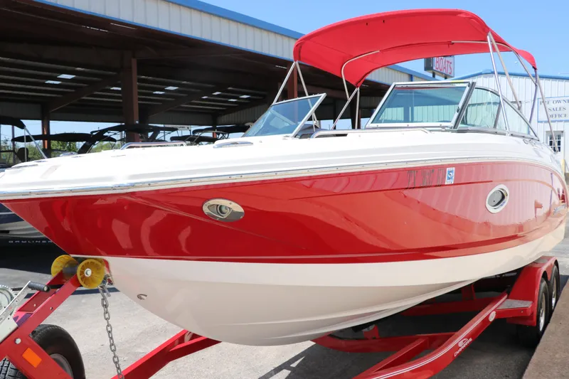 Slide: The Image of 2016 Chaparral 246 SSi boat with red and white exterior on a trailer. - 8