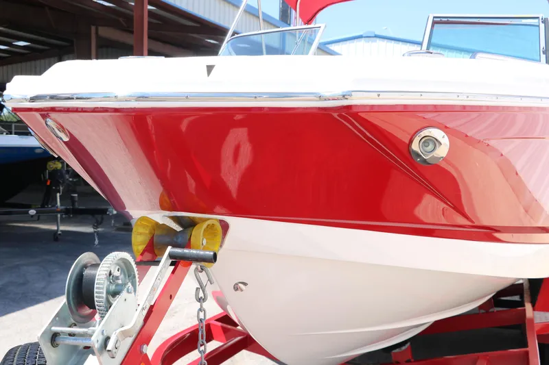 Slide: The Image of Red and white 2016 Chaparral 246 SSi boat on trailer in a marina. - 9