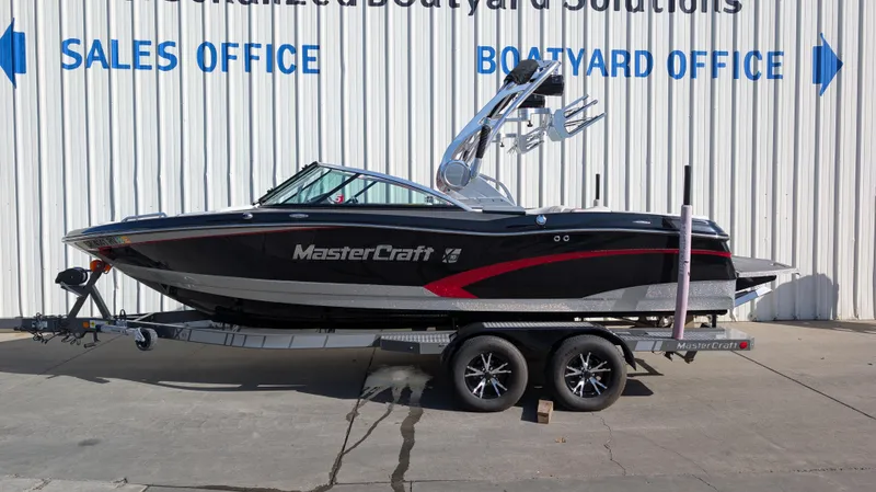 The Image of 2015 MasterCraft X10 boat on trailer outside sales and boatyard office. - 0