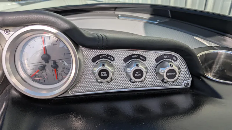 Slide: The Image of Dashboard controls of a 2015 MasterCraft X10 boat, featuring gauges and switches. - 10