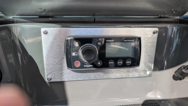 Slide: The Image of Control panel of a 2015 MasterCraft X10 boat featuring a Fusion audio system. - 12