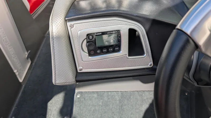 Slide: The Image of 2015 MasterCraft X10 boat dashboard with control panel and steering wheel. - 13