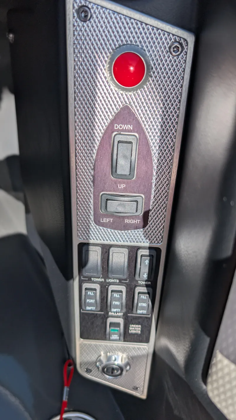 Slide: The Image of Control panel of a 2015 MasterCraft X10 boat with switches and buttons. - 14