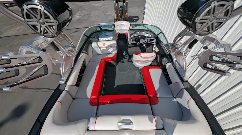 Slide: The Image of 2015 MasterCraft X10 boat interior with red and white seating, advanced audio system, and sleek design. - 18