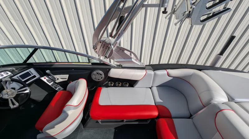 Slide: The Image of 2015 MasterCraft X10 boat interior with red and gray seating, modern dashboard, and sleek design. - 25