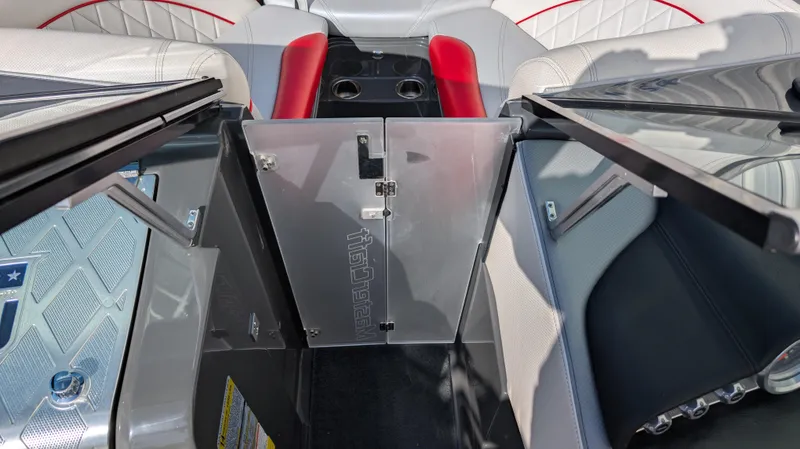 Slide: The Image of 2015 MasterCraft X10 boat interior with red and white seating and center console. - 31