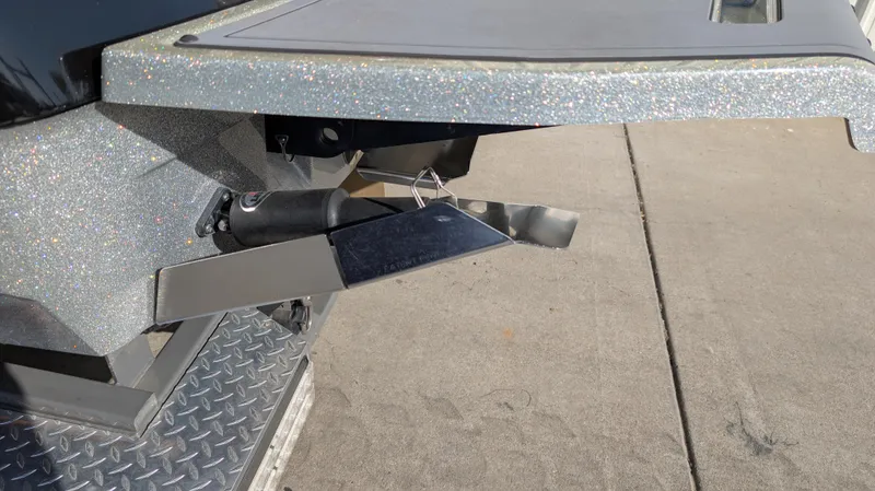 Slide: The Image of 2015 MasterCraft X10 boat detail showing metallic components on a concrete surface. - 37
