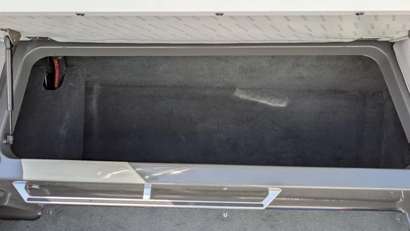 Slide: The Image of 2015 MasterCraft X10 storage compartment, spacious and carpeted interior. - 41