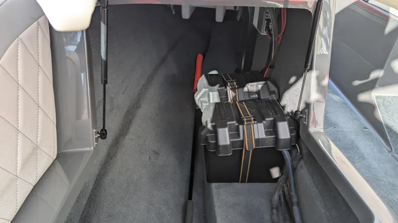 Slide: The Image of 2015 MasterCraft X10 interior storage compartment with battery and wiring. - 42