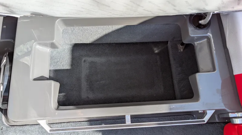 Slide: The Image of 2015 MasterCraft X10 boat storage compartment, gray interior, open lid. - 43