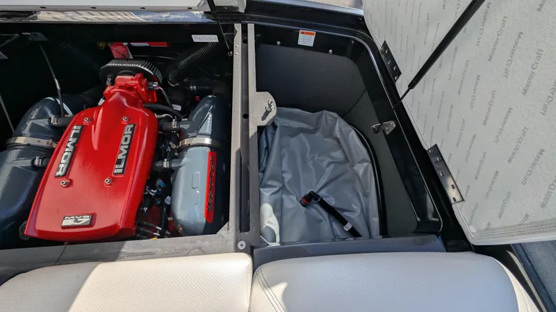 Slide: The Image of 2015 MasterCraft X10 engine compartment with red Ilmor engine and storage area. - 48