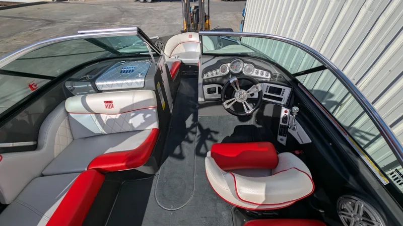 Slide: The Image of 2015 MasterCraft X10 boat interior with red and white seating, sleek dashboard, and modern controls. - 5