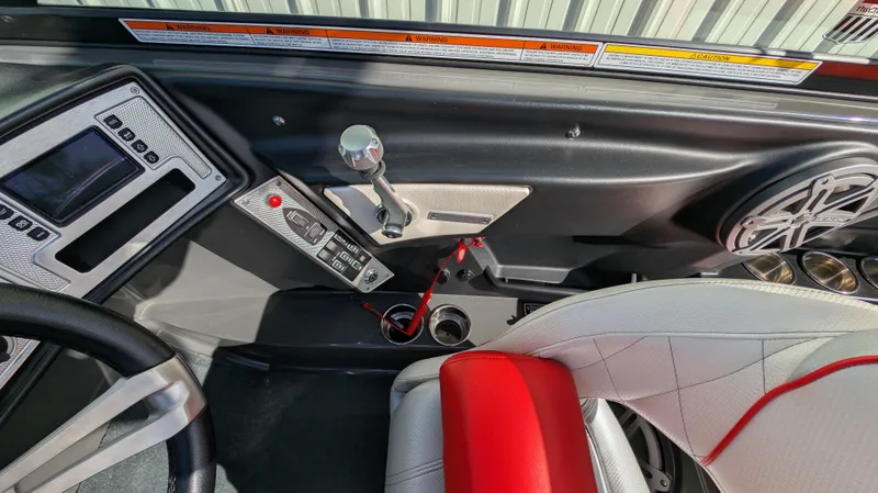 Slide: The Image of Interior of 2015 MasterCraft X10 boat with control panel and steering wheel. - 7
