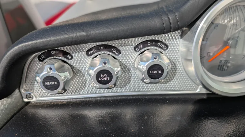 Slide: The Image of 2015 MasterCraft X10 dashboard controls for heater, navigation, and lights. - 9