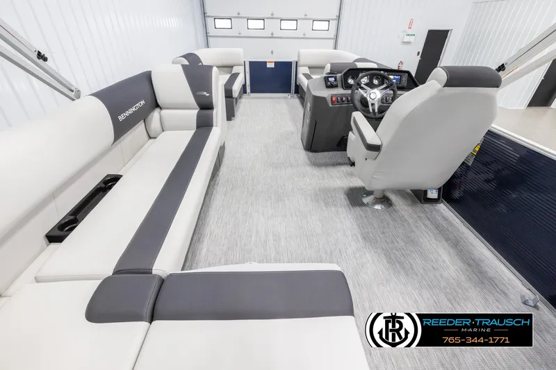 Slide: The Image of 2025 Bennington 20 SLSE pontoon boat interior with plush seating and modern helm. - 16