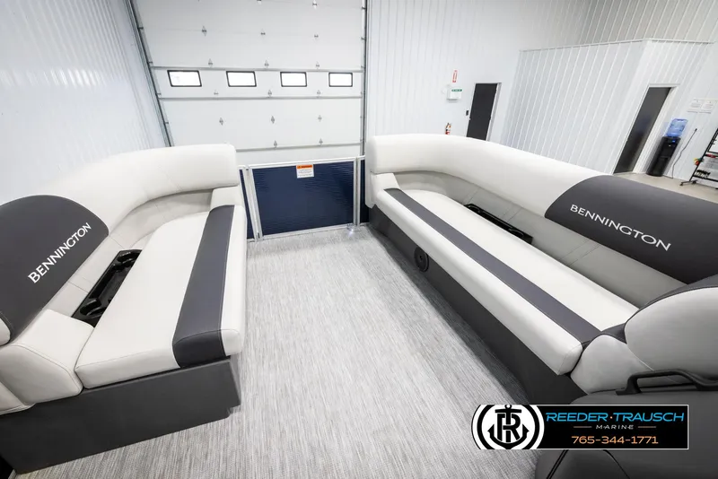 Slide: The Image of 2025 Bennington 20 SLSE pontoon boat interior with spacious seating in a showroom. - 19