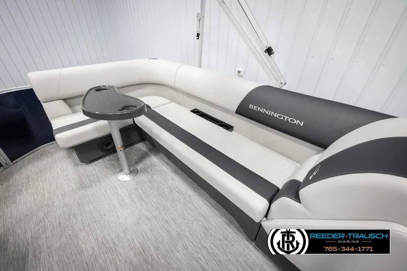 Slide: The Image of 2025 Bennington 20 SLSE pontoon boat interior with gray seating and table. - 26