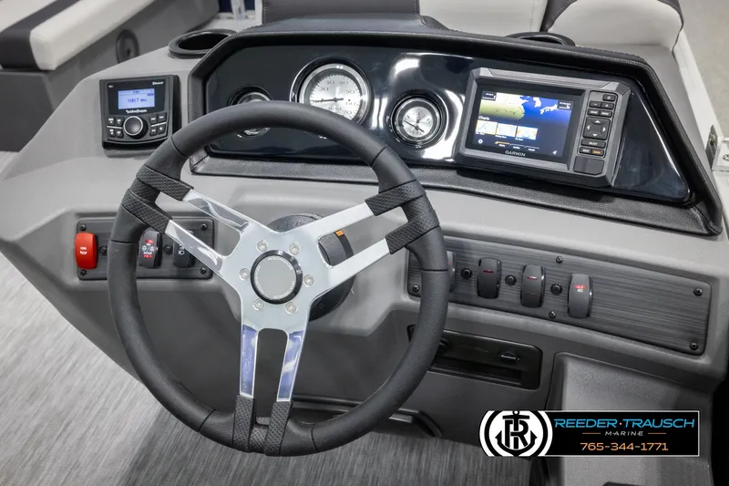 Slide: The Image of 2025 Bennington 20 SLSE boat dashboard with steering wheel, gauges, and navigation system. - 27