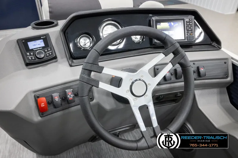 Slide: The Image of 2025 Bennington 20 SLSE boat dashboard with steering wheel, gauges, and control panel. - 28