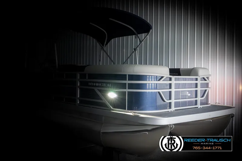 Slide: The Image of 2025 Bennington 20 SLSE pontoon boat with blue exterior, showcased in dim lighting. - 4
