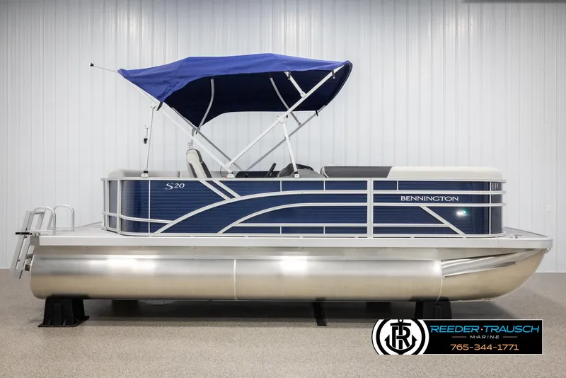 Slide: The Image of 2025 Bennington 20 SLSE pontoon boat with blue canopy and sleek design. - 5