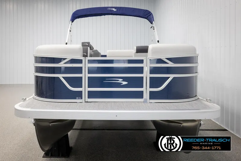 Slide: The Image of 2025 Bennington 20 SLSE pontoon boat with blue and white design, displayed indoors. - 8