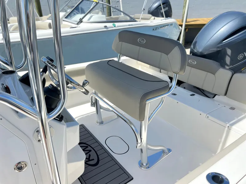 Slide: The Image of 2024 Key West 189 FS boat interior with gray seating and steering console. - 18