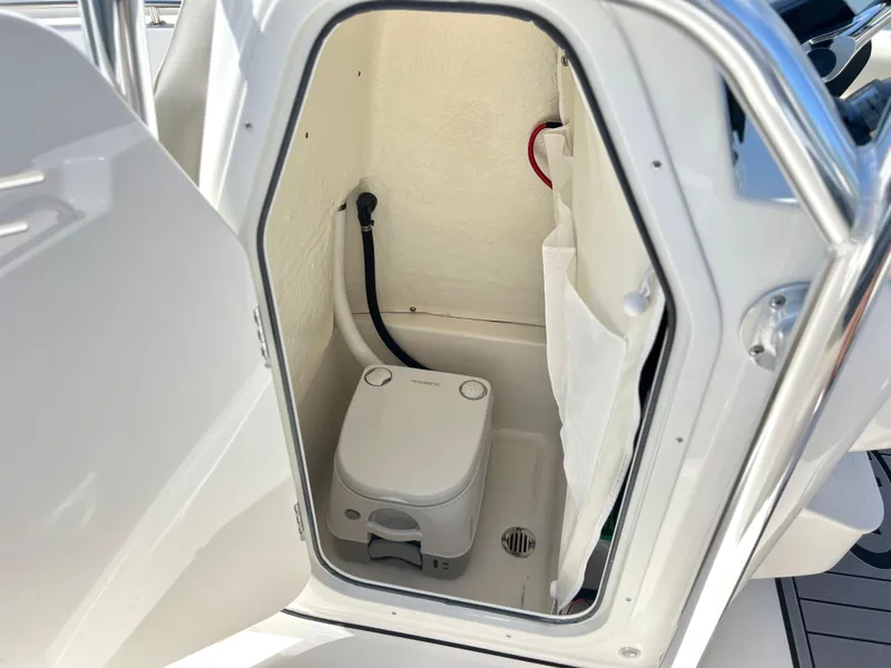 Slide: The Image of 2024 Key West 189 FS boat interior with compact marine toilet. - 21