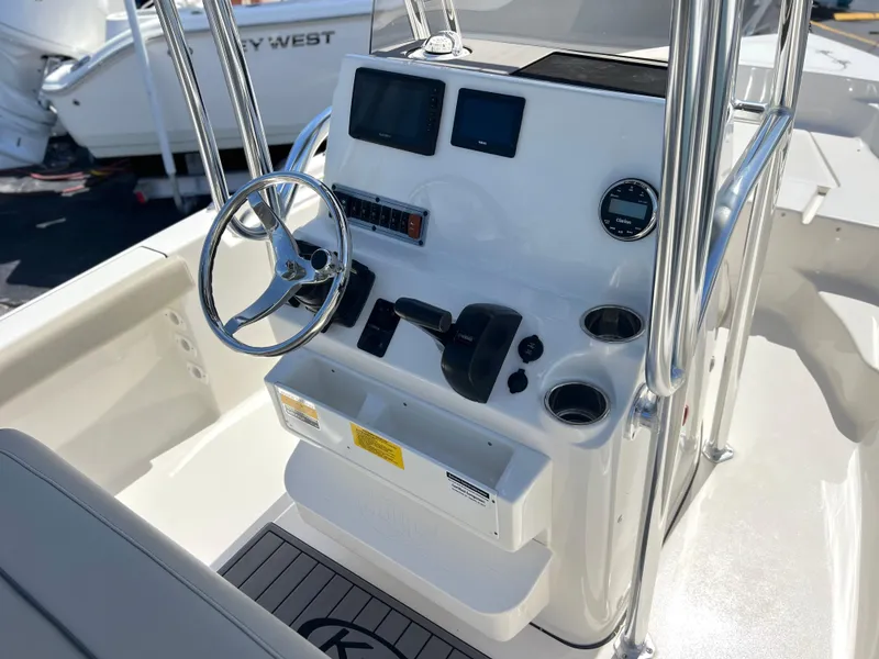 Slide: The Image of 2024 Key West 189 FS boat console with steering wheel and controls. - 23
