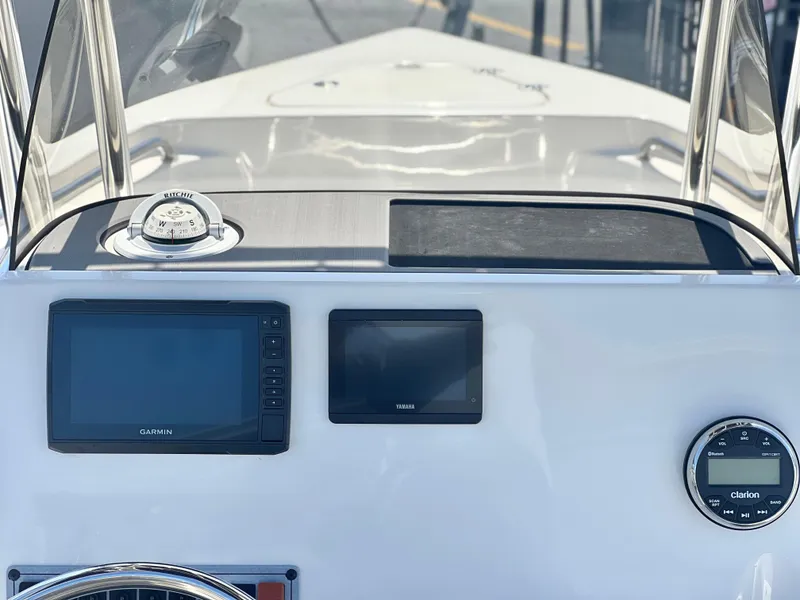 Slide: The Image of 2024 Key West 189 FS boat dashboard with Garmin display and compass. - 24