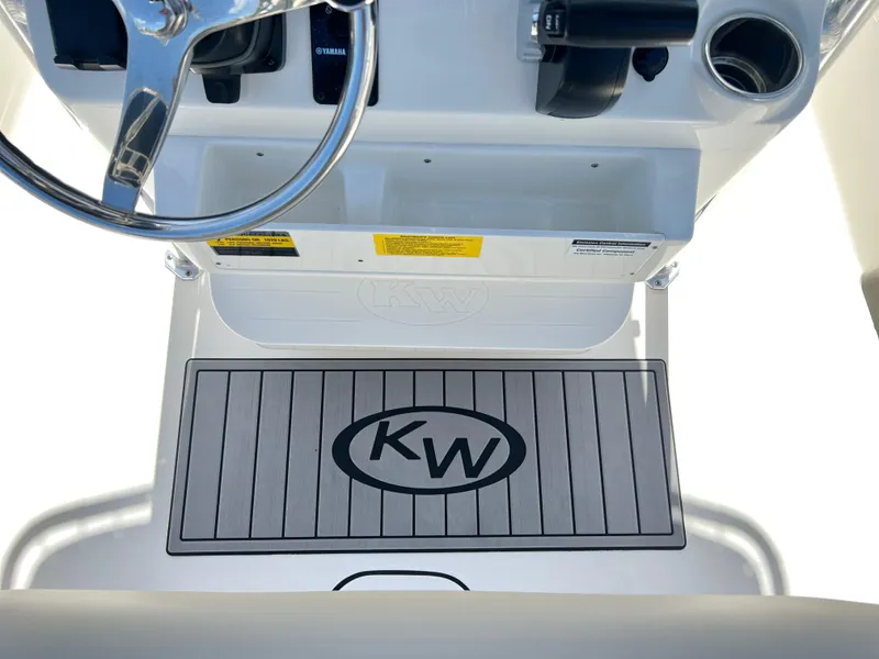 Slide: The Image of 2024 Key West 189 FS boat console with KW logo mat and steering wheel. - 25