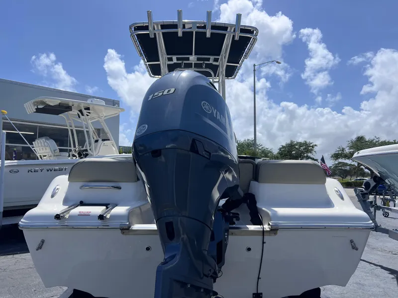 Slide: The Image of 2024 Key West 189 FS boat with Yamaha 150 engine, rear view under blue sky. - 4