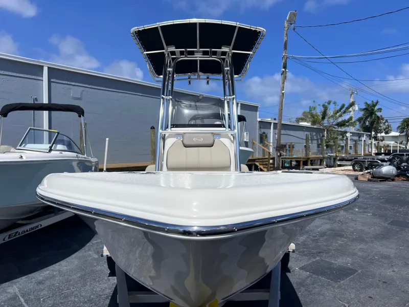 Slide: The Image of 2024 Key West 189 FS boat with T-top, parked outdoors on a sunny day. - 8