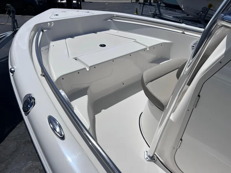 Slide: The Image of 2024 Key West 189 FS boat interior, featuring sleek seating and storage compartments. - 9