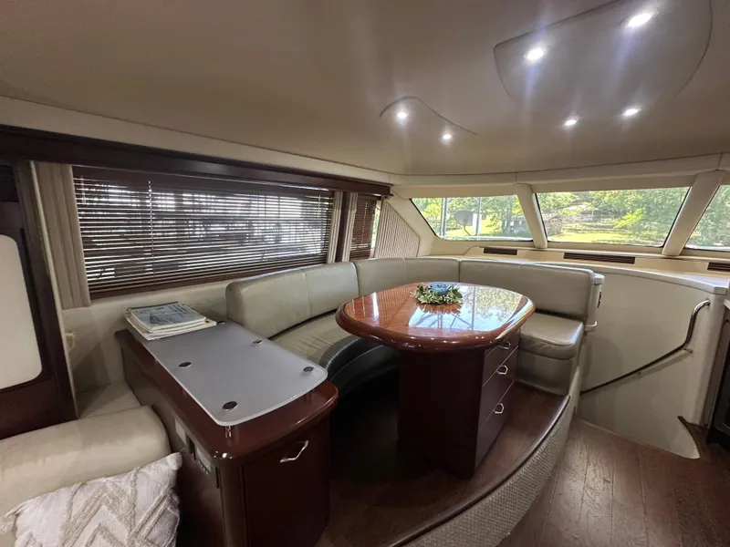 Slide: The Image of Luxurious interior of 2006 Sea Ray 58 Sedan Bridge yacht with elegant seating and table. - 11